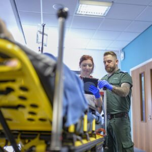 Emergency paramedics handing over patient to emergency nurse