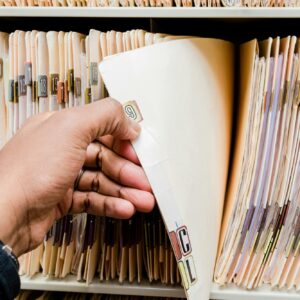 Medical records, charts, African American man sorting through patient charts